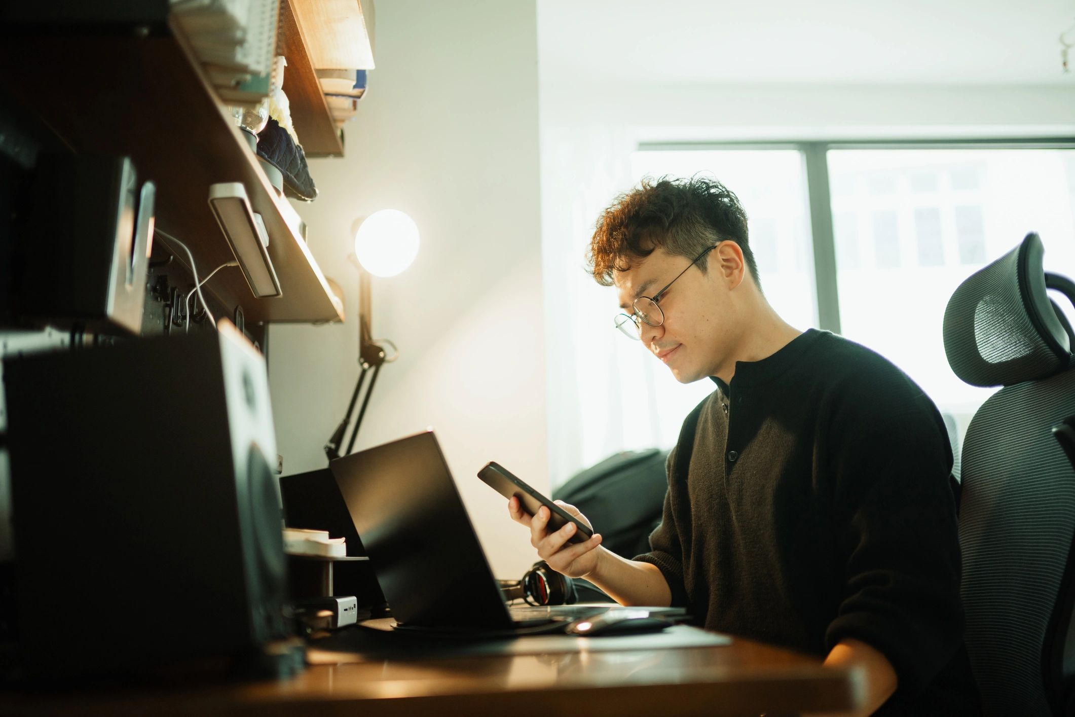 Writer working at a desk in a warm home office